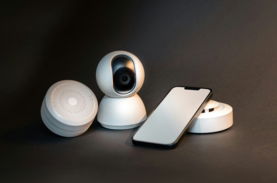 a-smart-phone-sitting-next-to-a-wireless-security-camera.jpg a smart phone sitting next to a wireless security camera